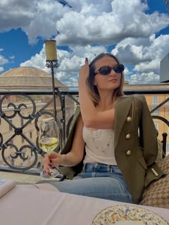 May be an image of wine glass, blazer and text