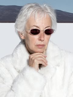 May be an image of one or more people, blonde hair, makeup, sable coat, glasses, sunglasses and text