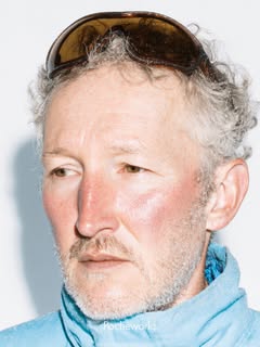 May be an image of one or more people, turtleneck, magazine, glasses and text